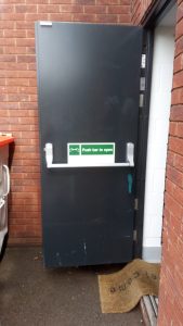 Black security door open with push bar handle