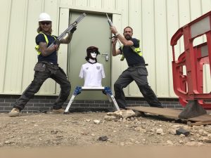 Men holding silicone guns with a mannequin in an England shirt