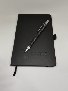 Black pen and pad with the Metador logo