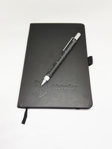 Black pen and pad with the Metador logo