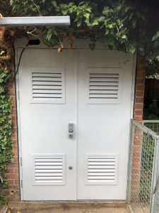White double security doors with louvres outside