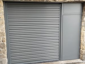 Black roller door with a black steel security door to the right