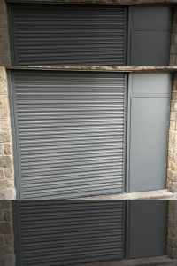 Black roller door with a black steel security door to the right