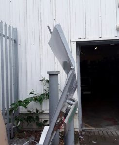 Crushed metal outside a warehouse