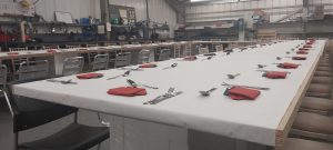 Large U shaped table laid out with cutlery