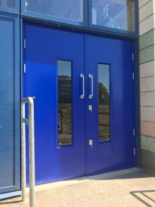 Blue double security doors on a blue frame outside
