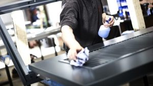 Man in an industrial area cleaning a service