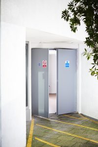 Open Grey security door in a white room