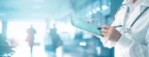 Doctor holding a tablet and a pen with a blurry background