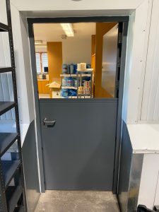 Grey door with top half missing