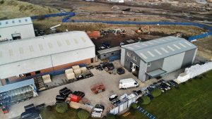 Image of industrial buildings from above with vehicles and other equipment outside