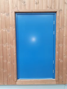 Blue security door surrounded by wood panelling
