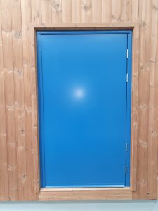 Blue security door surrounded by wood panelling