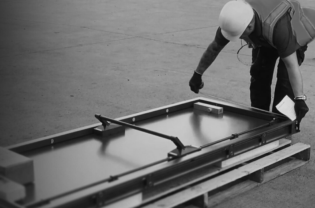 An Approved Installer lifting a steel Metador doorset
