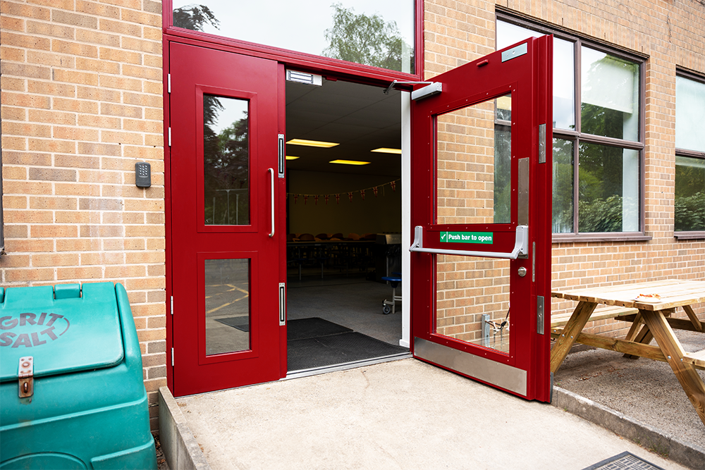 A Metador steel fire escape leaf and a half steel doorset, featuring large glazed vision panels