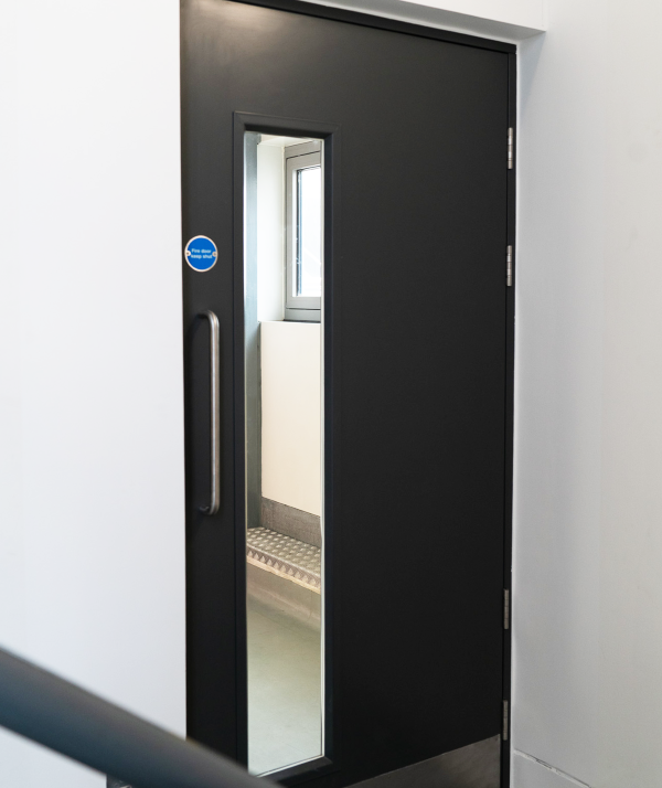 Single internal fire door in data centre with large glazing panel and pull handle