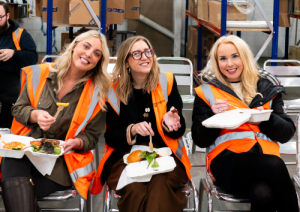 Three of the Metador team employees smile for the camera while enjoying the BBQ meet and eat lunch