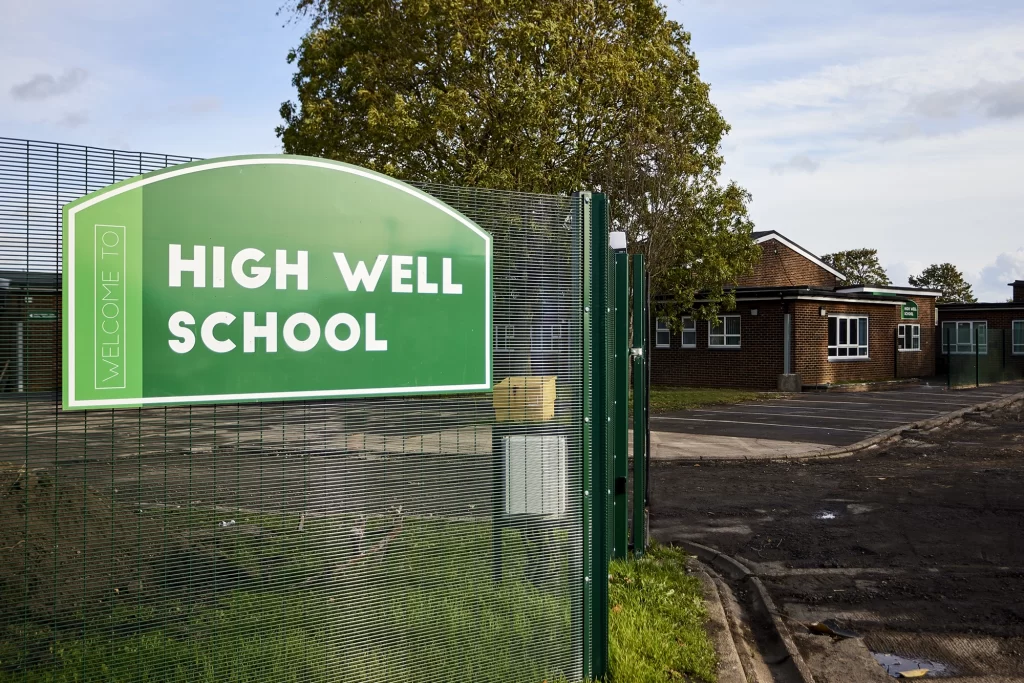 Image of external sign at High Well School, featured in Metador case study