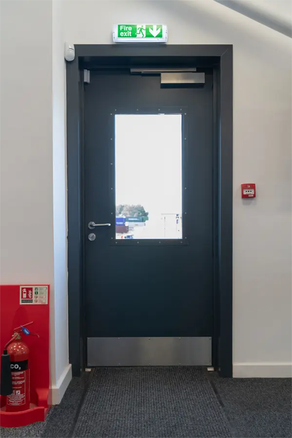 A Metador SafeguardX doorset with a BS EN 179 Emergency Exit lever handle.