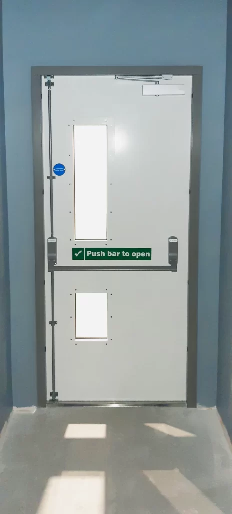 A Metador external fire rated, fire exit doorset with a BS EN 1125 panic escape push bar