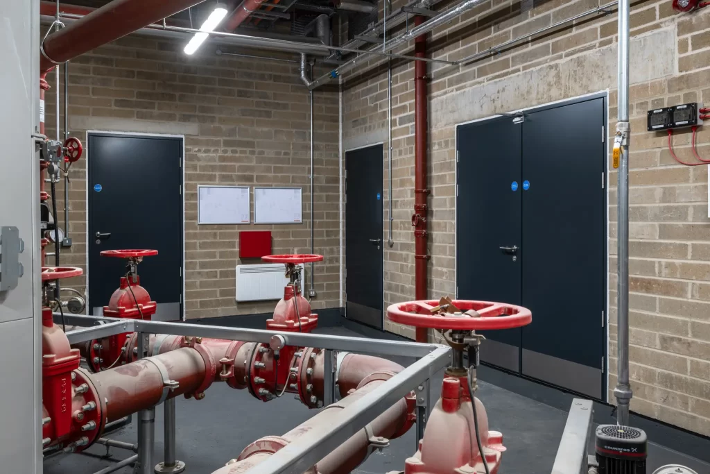 Utility room steel fire doors within large residential development